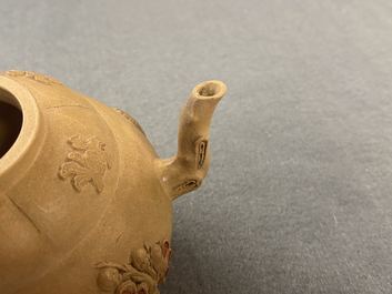 A bichrome Chinese Yixing stoneware teapot and cover with applied design, Kangxi